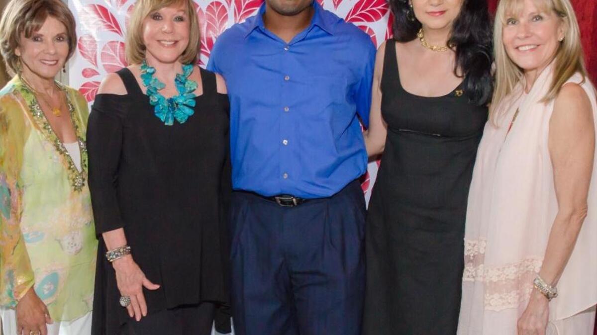 Helping to raise funds for the Lori Brener Scholarship Fund of the Women’s Committee Big Brothers Big Sisters are, from left: Miriam Salazar, Sonia Gibson, Darrin Smith, Julia Alba and Neyda Raola.