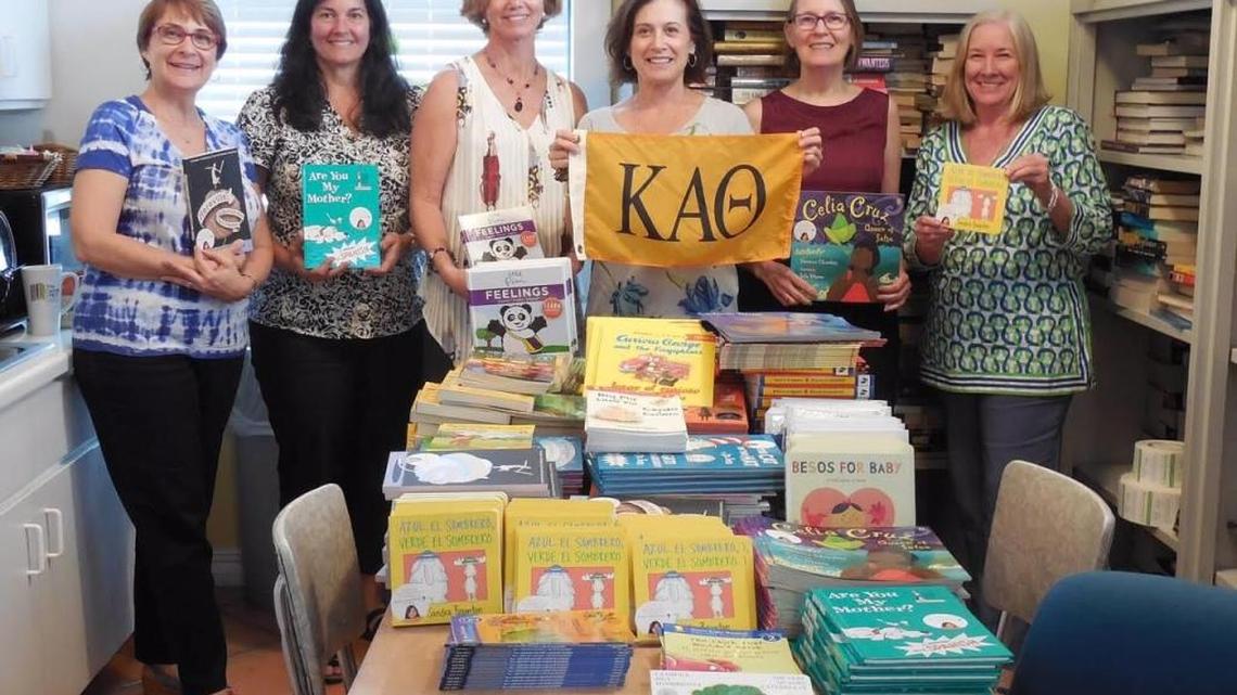 Helping with book donations for children are members of the Miami Alumnae Chapter of Kappa Alpha Theta women's fraternity, from left, Andrea Mustelier, Annette Tellez, Kit Wills, Kirstie Bray, Carrie Cleland, and Gayle Bainbridge.