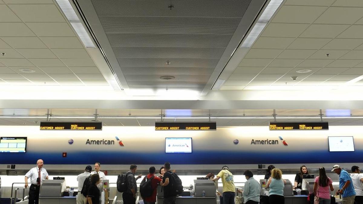 Local and international travelers wait in line for the security checkpoint at Miami International Airport on May 26, 2016.