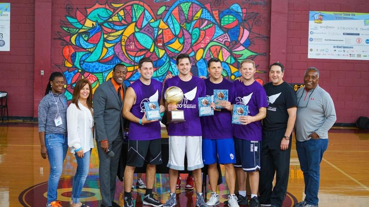 The 2016 winners of Zo’s Hoop-Law Madness 3-on-3 Charitable Basketball Tournament celebrate raising funds for the Overtown Youth Center.