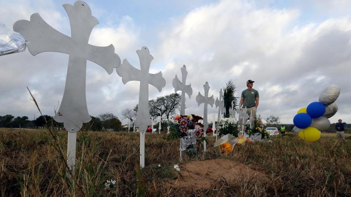 Kyle Dahlberg visits a makeshift memorial for victims near the scene of a shooting at the First Baptist Church of Sutherland Springs, Tuesday, Nov. 7, 2017, in Sutherland Springs, Texas. A man opened fire inside the church in the small South Texas community on Sunday, killing more than two dozen and injuring others.