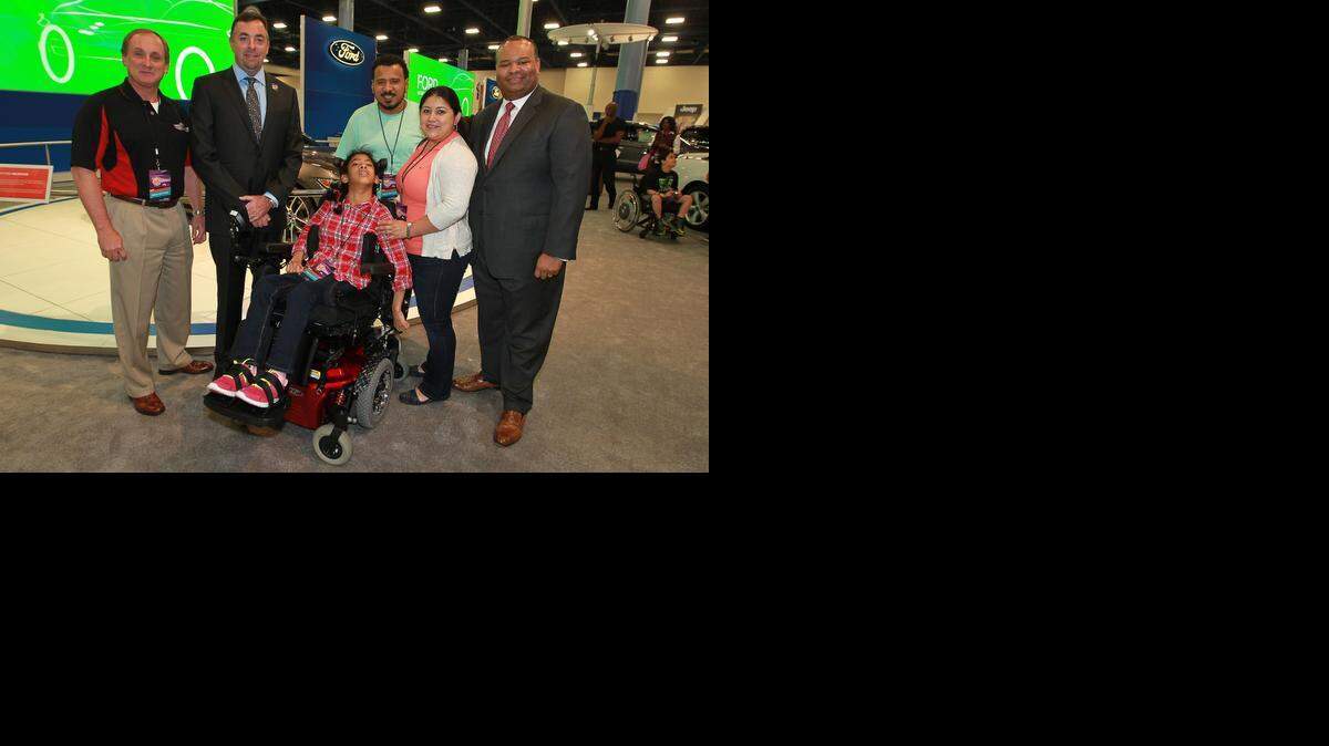 
Kaylee Oseguera is presented with a new wheelchair at the Miami Auto Show by the Darrell Gwynn Foundation and Ford. From left are Todd Payne, chairman of the board for Darrell Gwynn Foundation; Mike Hooley, president at Plantation Ford; Kaylee; her dad Hermes Oseguera; and mom Lindsey Oseguera; and Jim Gwaltney, Ford regional sales manager.
