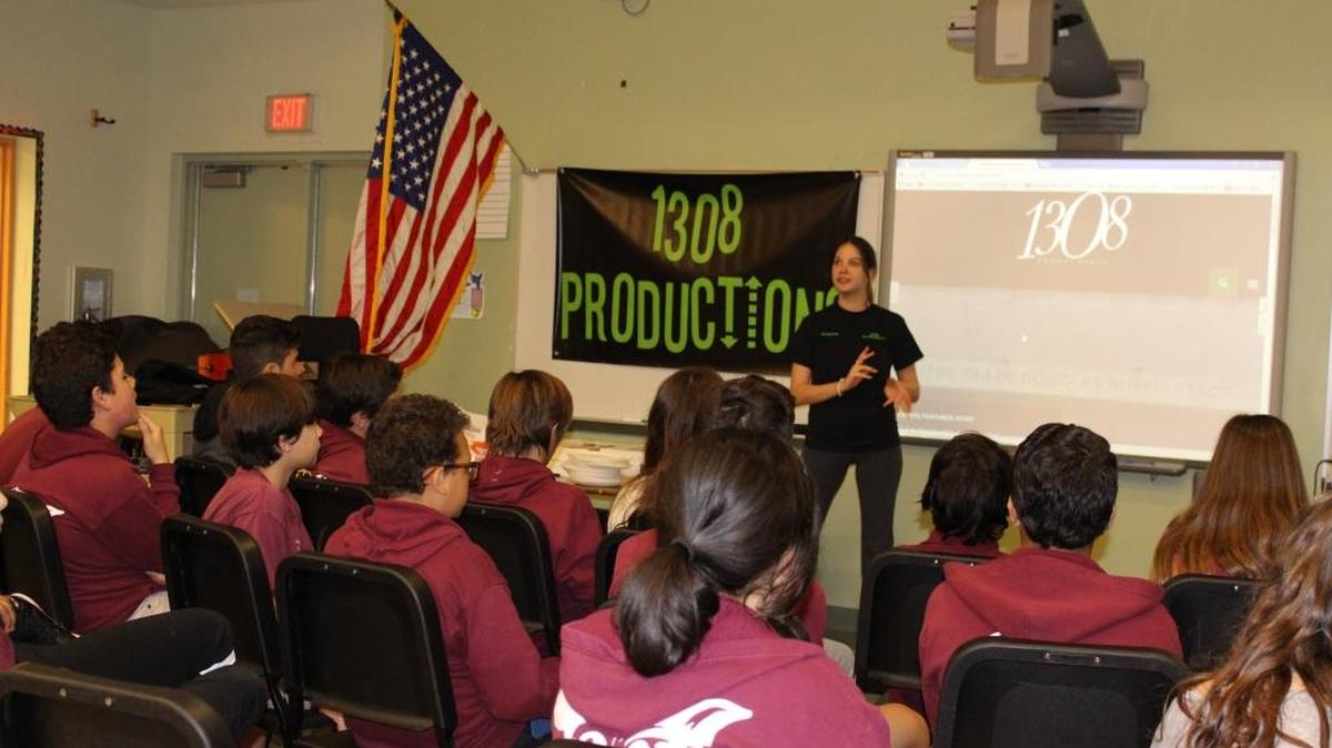 Allison Novack, co-founder of 1308 Productions, speaks with the music students at Ruth K. Broad/Bay Harbor K-8 Center about public service. Her group also donated keyboards and amplifiers to the school’s music program.