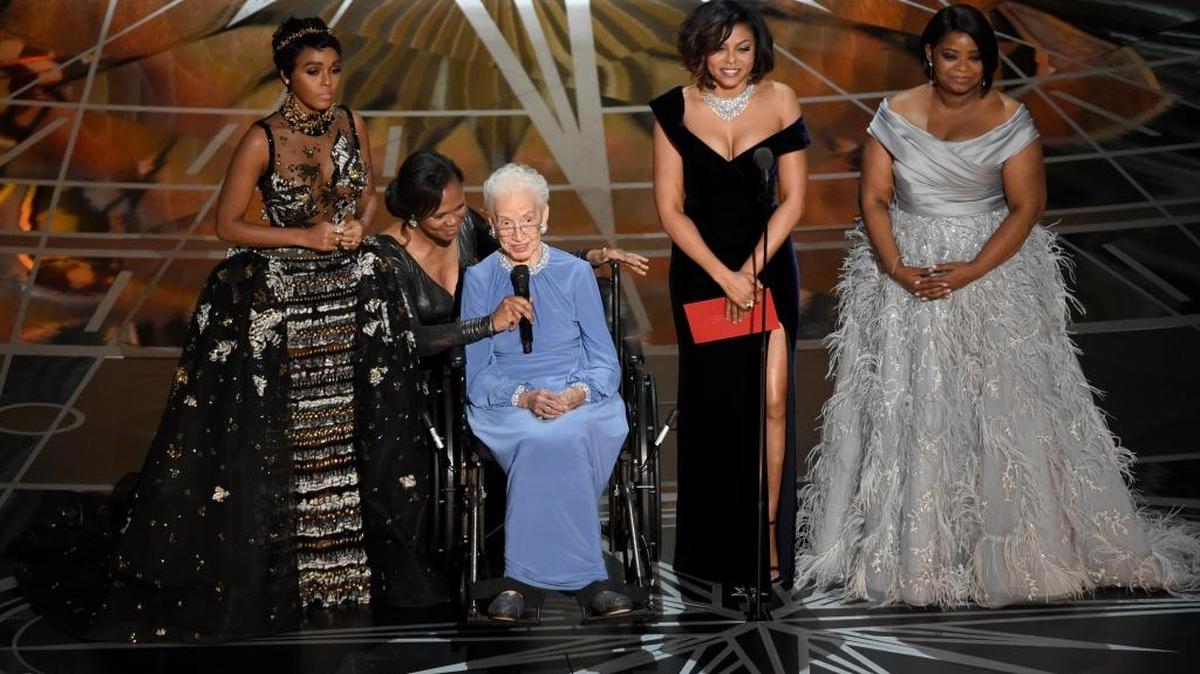 Janelle Monae, left, Taraji P. Henson, second right and Octavia Spencer, right, introduce Katherine Johnson, seated, the inspiration for ‘Hidden Figures,’ as they present the award for best documentary feature at the Oscars on Sunday, Feb. 26, 2017, at the Dolby Theatre in Los Angeles.
