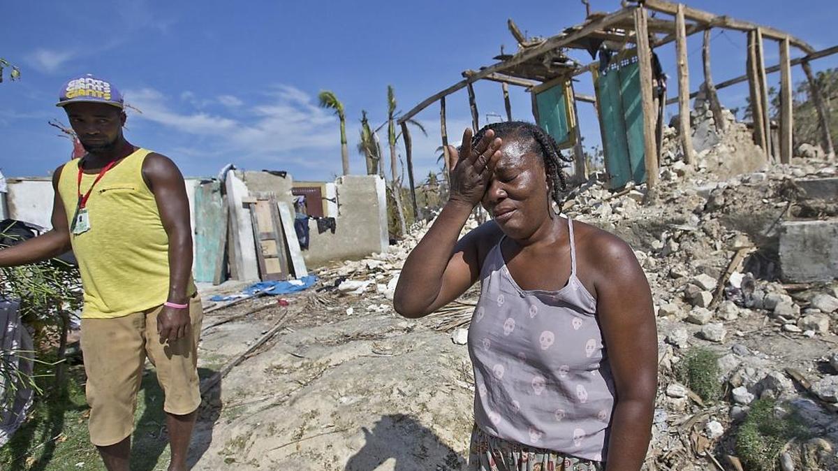 Hurricane Matthew victim Marie Louse Valentin 54, weeps in front of her shattered home in Morne la Source, Haiti on Sunday, Oct. 9, 2016.