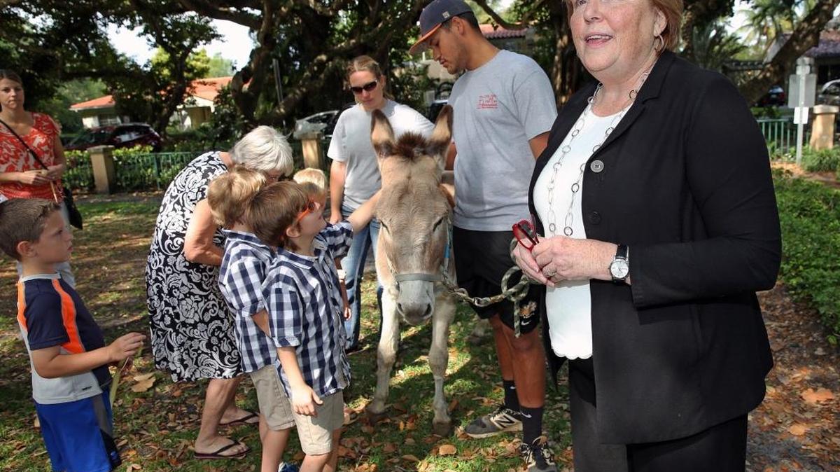 The Reverend Dr. Laurinda Hafner, senior pastor of the Coral Gables Congregational United Church of Christ, speaks to her congregation during the donkey parade in celebration of Easter Sunday Week.