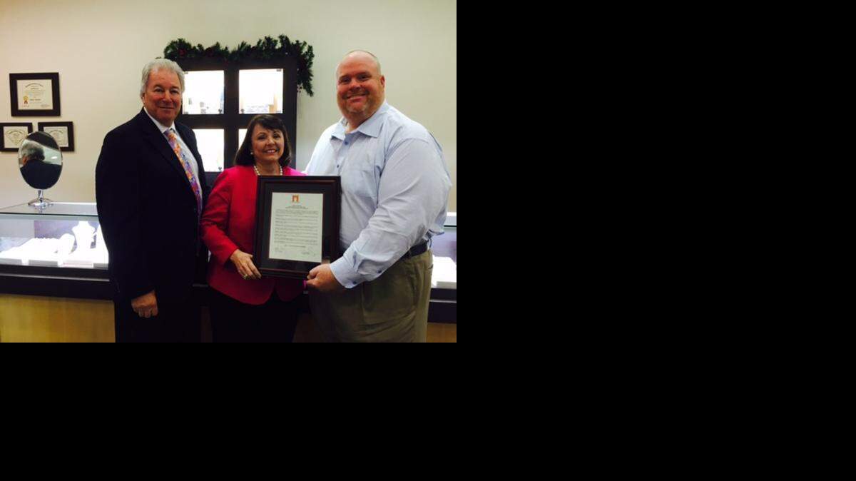 
Jewelers Eddie and Judy Snow receive a proclamation for their 40 years in business on Coral Gables’ Miracle Mile from Mark Trowbridge.
