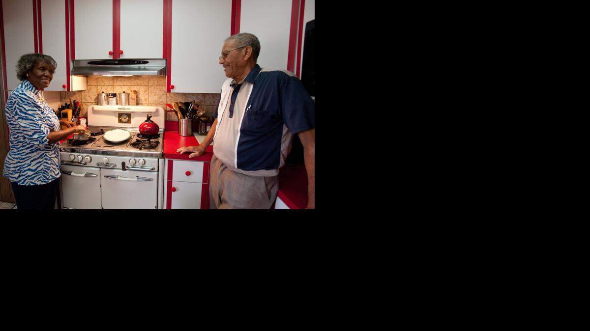 
Queen Ester Armstrong cooks on a 64-year-old O'Keefe and Merritt gas stove as her husband Samuel D. Armstrong Sr. stands by, Saturday, Nov. 15, 2014, at their home in Richmond Heights.
