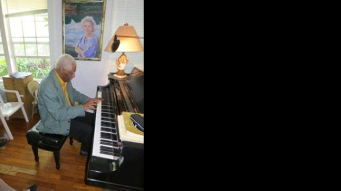 
Overtown resident James Ford plays the piano. Above him is a portrait of his teacher, mentor and friend, Ruth Greenfield. Greenfied’s husband, Arnold, painted the portrait in 1990.
