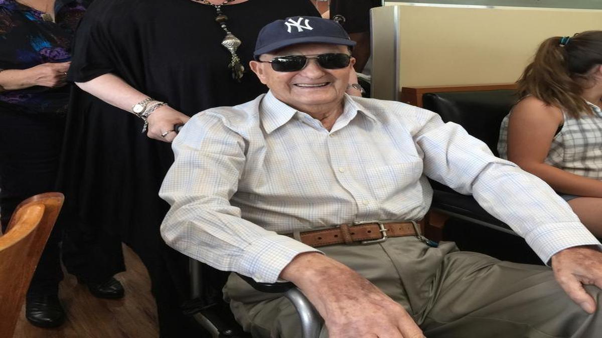Jack Snitkin, with daughter Linda Vono, arrives at his 105th birthday party Saturday at Mo’s Bagel and Deli in Aventura.
