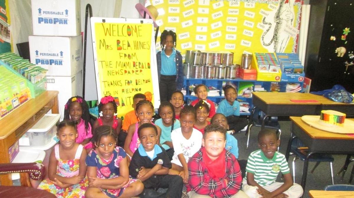 Students at Beacon Hill Prep School in Miami Gardens, who collected supplies for the Haiti relief effort, welcome Miami Herald columnist Bea L. Hines.