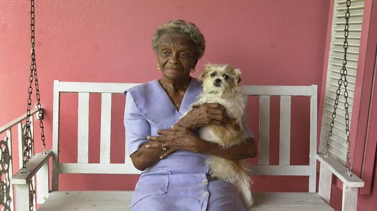 In 2002: Dorothy Edwards on the porch of her home in Liberty City with her dog, Tiny.