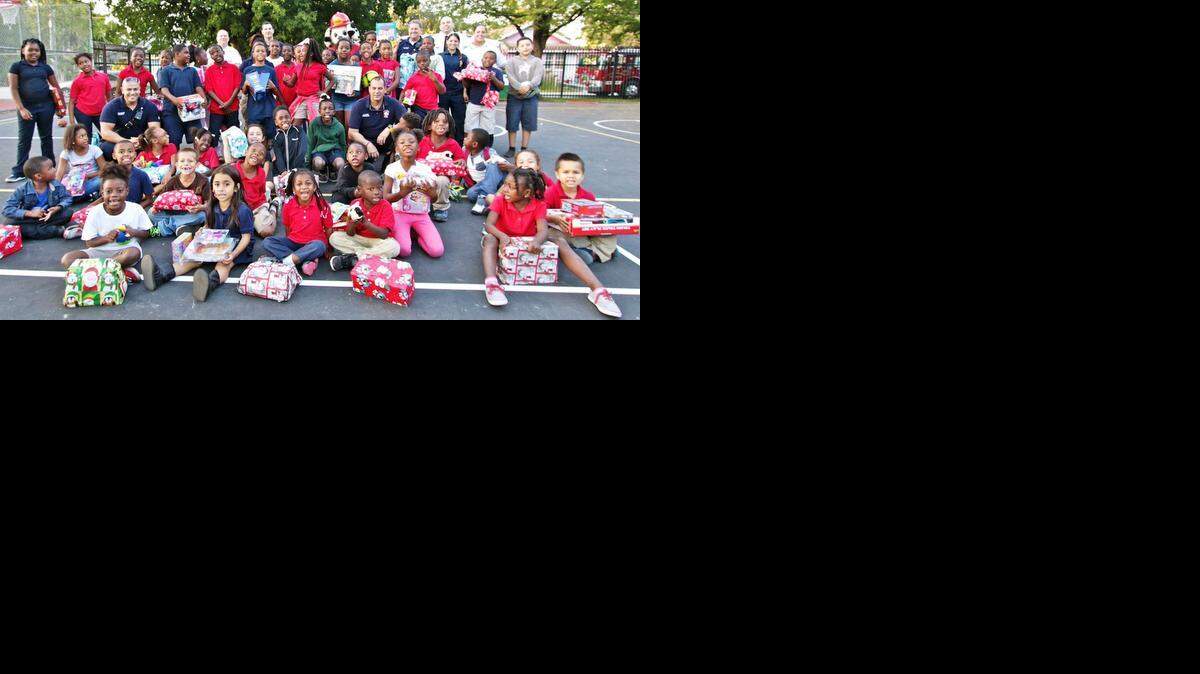 
Coral Gables Fire Fighters, Explorers, Sparky the Dalmatian, and the children of the Barnyard Community Center celebrate with toys donated by the community.
