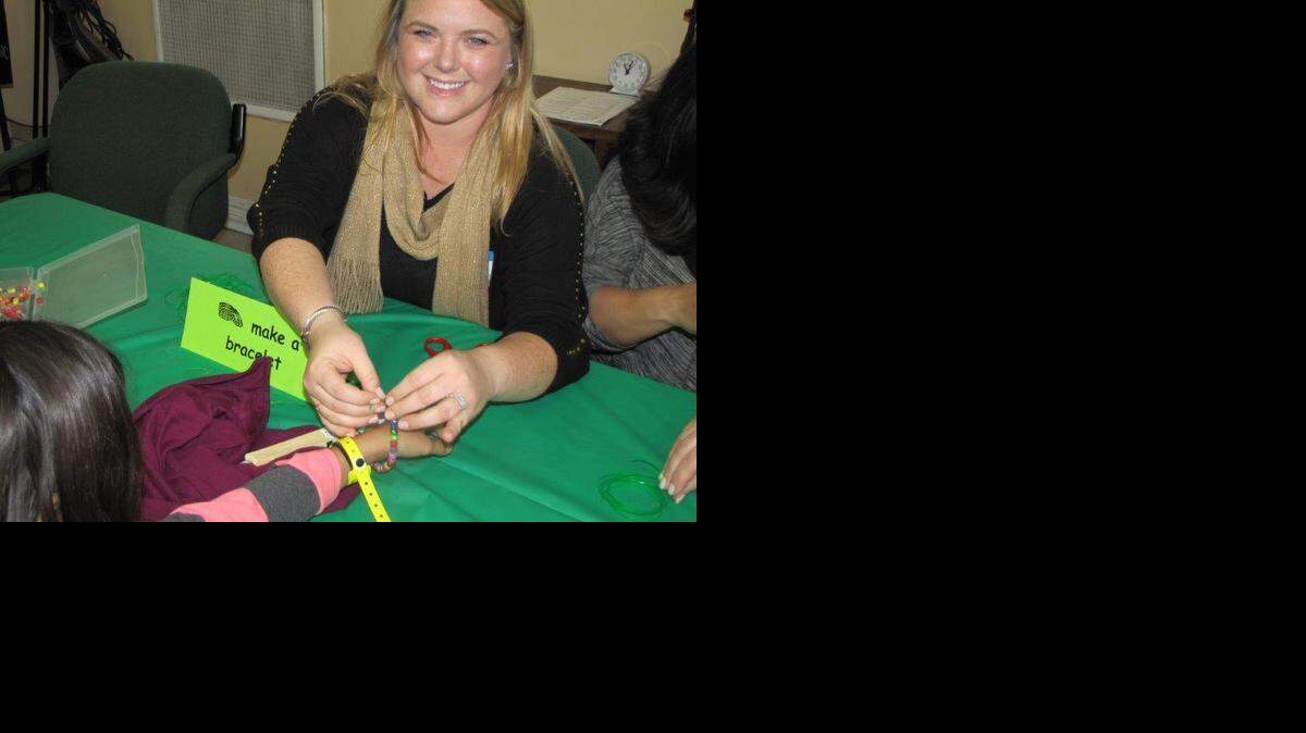
Ashley Wheeler, a junior member of Young Patronesses of the Opera and daughter of YPO President Lisa Wheeler, helps with opera-related crafts at the Girl Scout Workshop.
