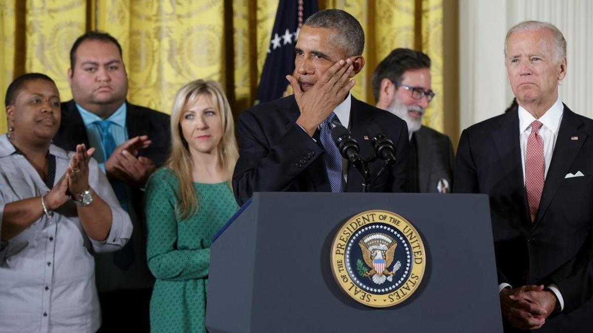President Barack Obama wipes tears from his face as he speaks in the East Room of the White House in Washington, Tuesday, Jan. 5, 2016, about steps his administration is taking to reduce gun violence. Also on stage are Vice President Joe Biden, right, and stakeholders, and individuals whose lives have been impacted by the gun violence.