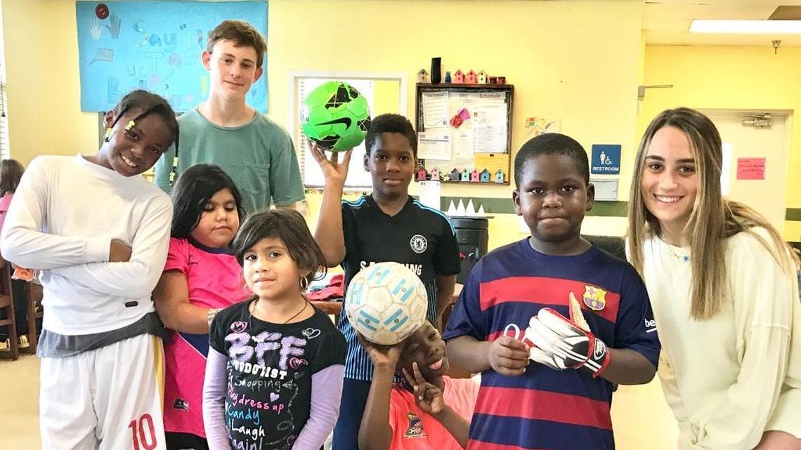 Palmetto Senior High senior Mica Wenger, right, makes regular deliveries of donated soccer equipment and clothes to the children at the Chapman Partnership.