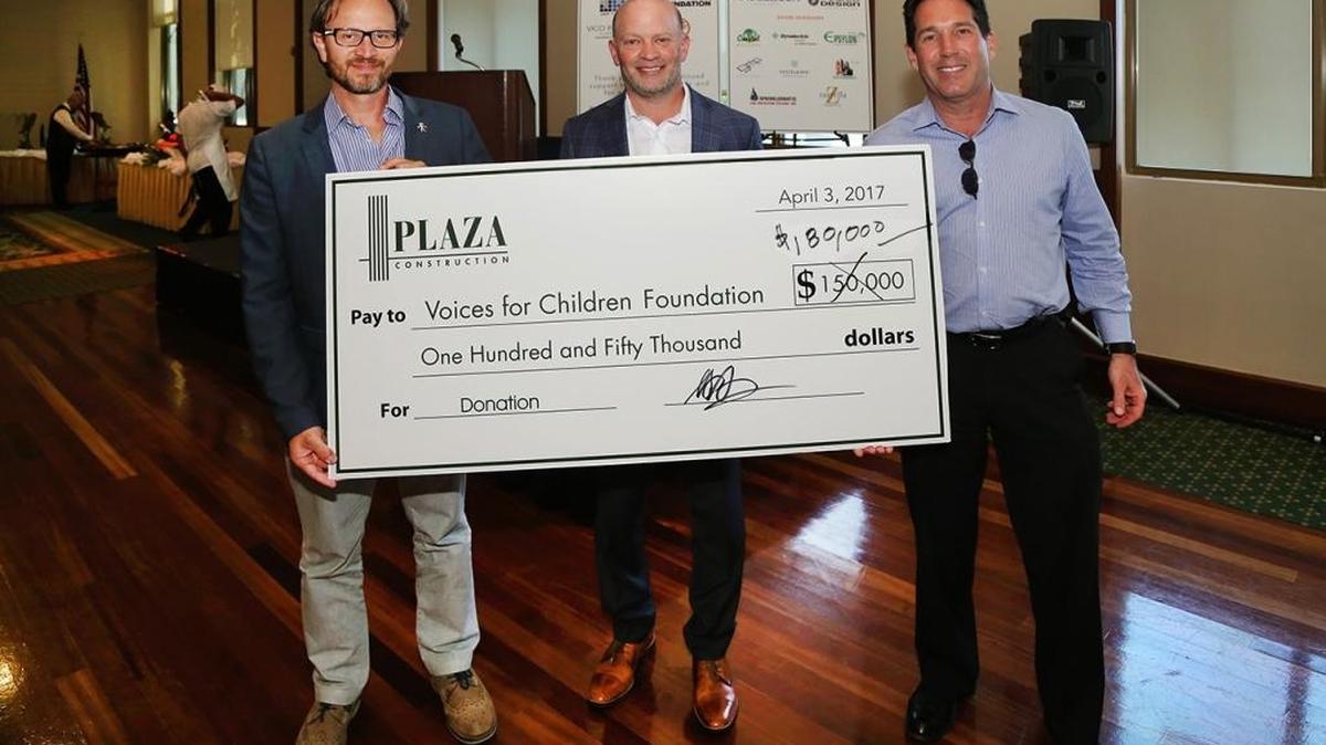 Plaza Construction presents a check for $180,000 to Voices For Children Foundation at Plaza’s 11th annual Golf Invitational at La Gorce Country Club on April 3. Accepting the check from tournament host and foundation board member Brad Meltzer, president of Plaza’s Southeast Region, center, were Voices For Children Foundation’s President and CEO Nelson Hincapie, left, and foundation Board Chairman Jay Shapiro, a shareholder at Stearns Weaver Miller, P.A., right.