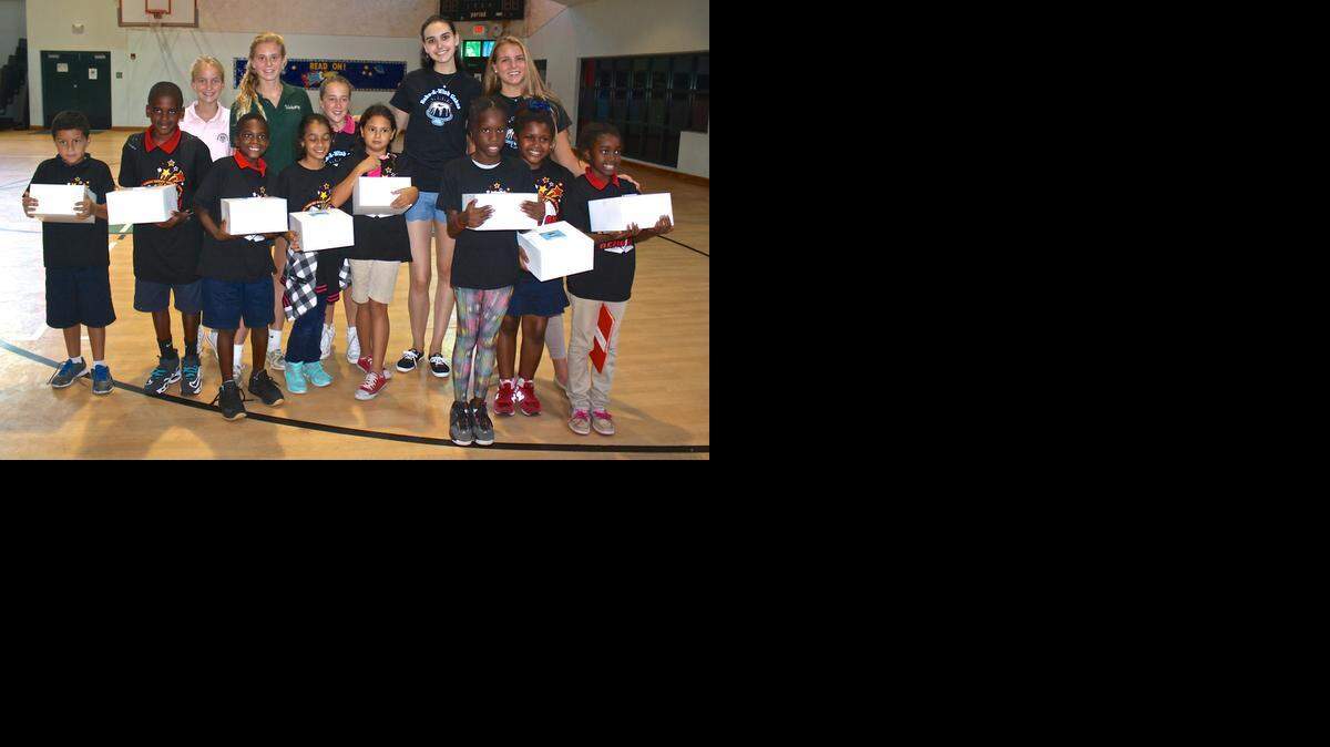 
Bake-A-Wish Cakes Miami team members celebrate with kids in the after school program at Elizabeth Virrick Park in Coconut Grove. From left are Georgia Murphy, Natasha Strump, Sloan Cole, Marielle Ogilby, and Founder Katie Pfleger.
