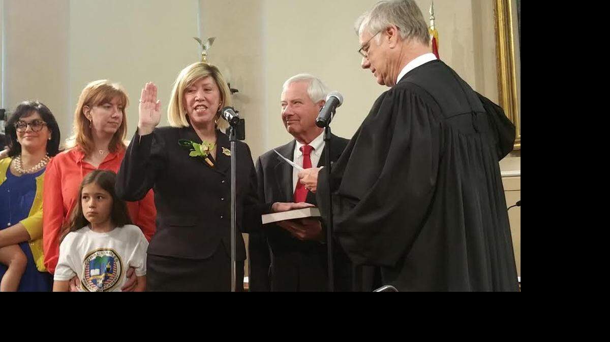 
New Commissioner Jeannett Slesnick takes the oath of office on Friday, standing beside her husband, former Coral Gables Mayor Don Slesnick.
