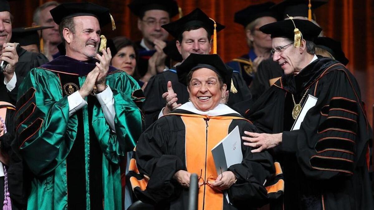 Former University of Miami President Donna Shalala, now the chief executive of the Clinton Foundation, is applauded by University of Miami Board of Trustees Chair Stuart Miller and UM President Julio Frenk on Thursday, December 15, 2016. Shalala delivered the commencement speech at today's UM graduation.