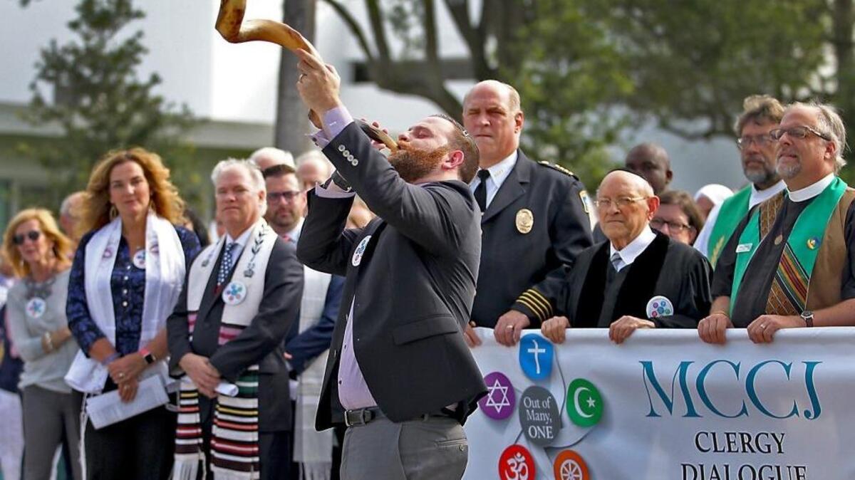 Assistant Rabbi Jonathan Fisch of Temple Judea blows the Shofar as leaders from nearly 30 different congregations gather outside of Temple Judea in Coral Gables on Sunday, Sept. 11, 2016 to mark the 15th Anniversary of the 9/11 attacks.