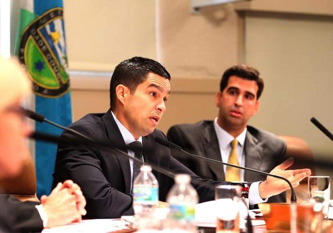 Coral Gables City Commissioner Vince Lago addresses a speaker as commissioner Frank Quesada looks on at a special meeting of the Coral Gables commission on Thursday, Sept. 11, 2014 to go over crime statistics, after a wave of burglaries in the city, which led to the police chief resigning on Weds. Sept. 10, 2014.