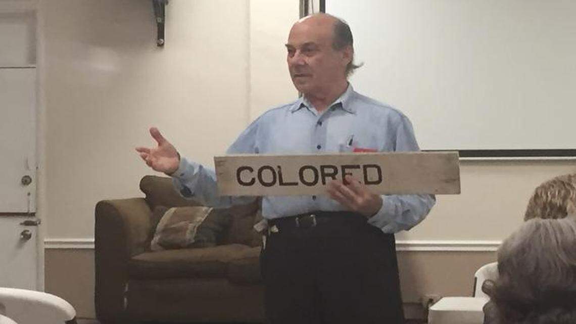 
Historian Seth Bramson shows off a sign that was in the waiting room of a Florida East Coast Railway station during the Jim Crow era. 

