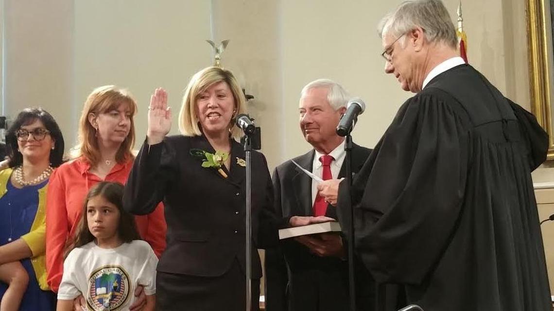 Commissioner Jeannett Slesnick takes the oath of office in April 2015, standing beside her husband, former Coral Gables Mayor Don Slesnick.