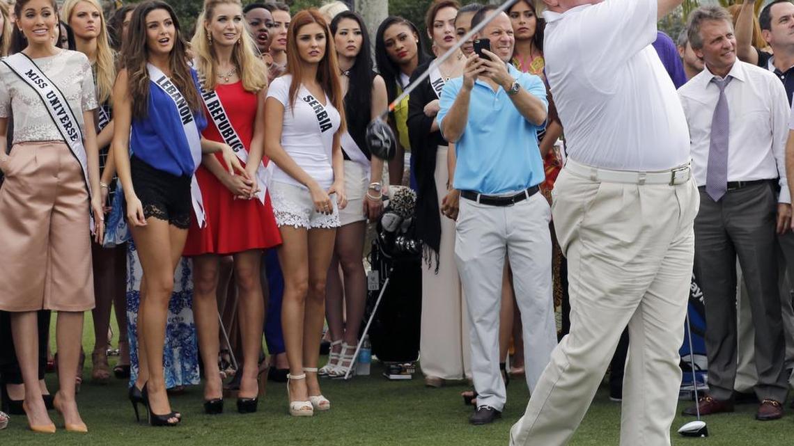 Donald Trump, right, gets it done as he tees off on the Red Tiger golf course. Miss Universe contestants along with Donald Trump teed off on the newly renovated “Red Tiger” golf course at Trump International Doral Miami on Monday, January 12, 2015.