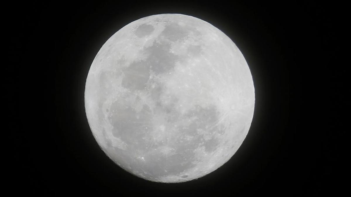 The moon appears from the sky in the first supermoon of 2018 as seen from suburban Makati city east of Manila, Philippines, on Monday, Jan. 1, 2018. A “Super Blood Blue Moon” is expected later this month; scientists say that “supermoon” will coincide with a total lunar eclipse. A “supermoon” occurs when the moon appears bigger and brighter in the sky.