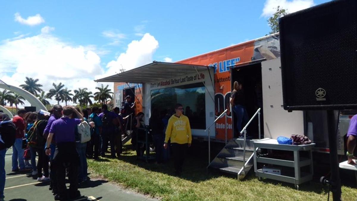 Students from Cutler Bay High School collaborate with the Miami-Dade Police Department, Miami-Dade Public School Police and Students Together Against Negative Decisions (STAND) on Tuesday to learn about driving while under the influence.