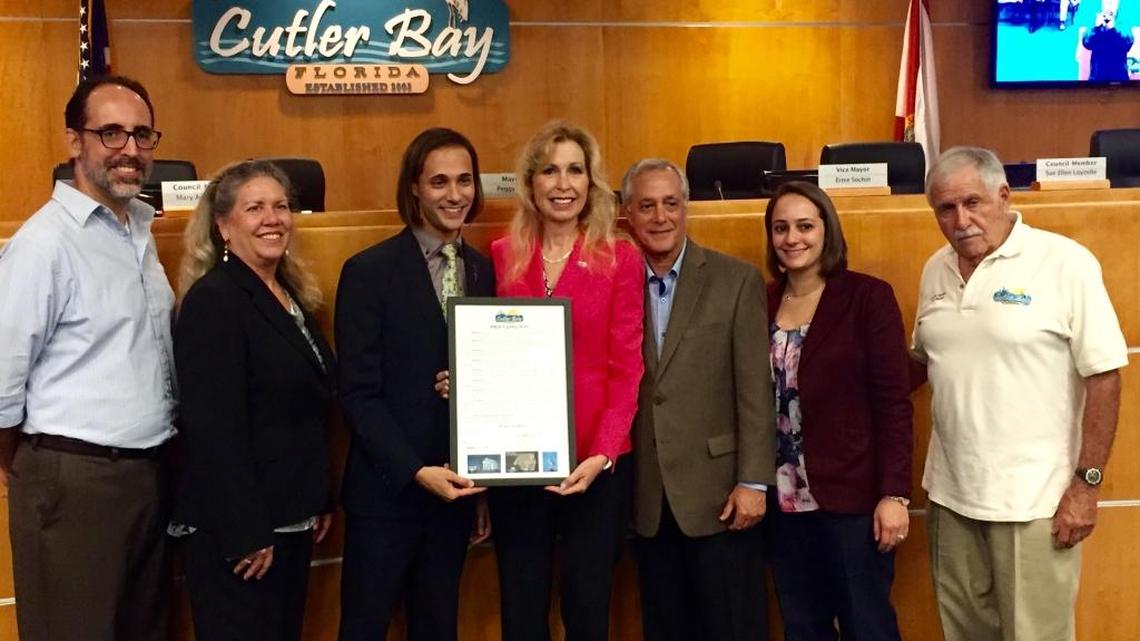 Cutler Bay Councilman Roger Coriat, Councilwoman Sue Ellen Loyzelle, teacher Justin Koren of Cutler Bay Senior High School, Mayor Peggy Bell, Koren’s father and sister, and Vice Mayor Ernie Sochin.