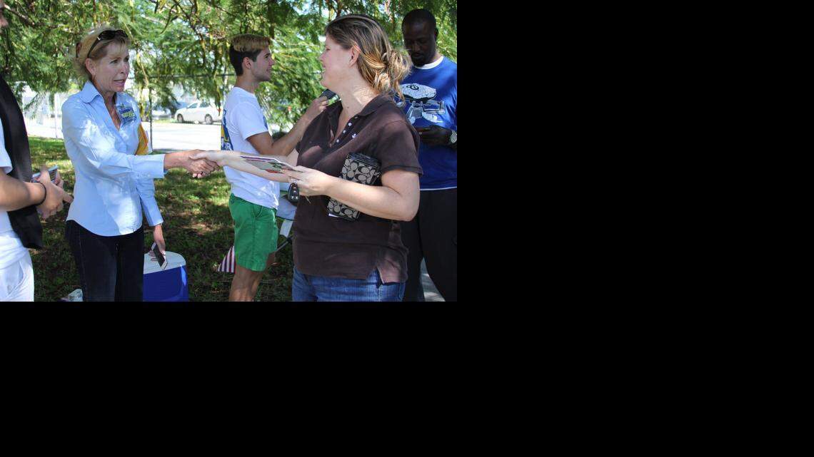 
AT THE POLLS: Peggy Bell greets voters at a precinct located at Cutler Bay Academy of Advanced Studies-Centennial Campus on Tuesday. Bell defeated retired police officer Art Nanni on Tuesday to become the town’s next mayor.
