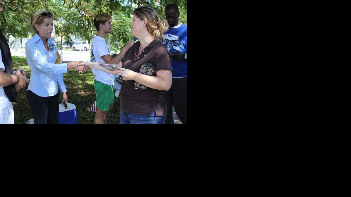 
AT THE POLLS: Peggy Bell greets voters at a precinct located at Cutler Bay Academy of Advanced Studies-Centennial Campus on Tuesday. Bell defeated retired police officer Art Nanni on Tuesday to become the town’s next mayor.
