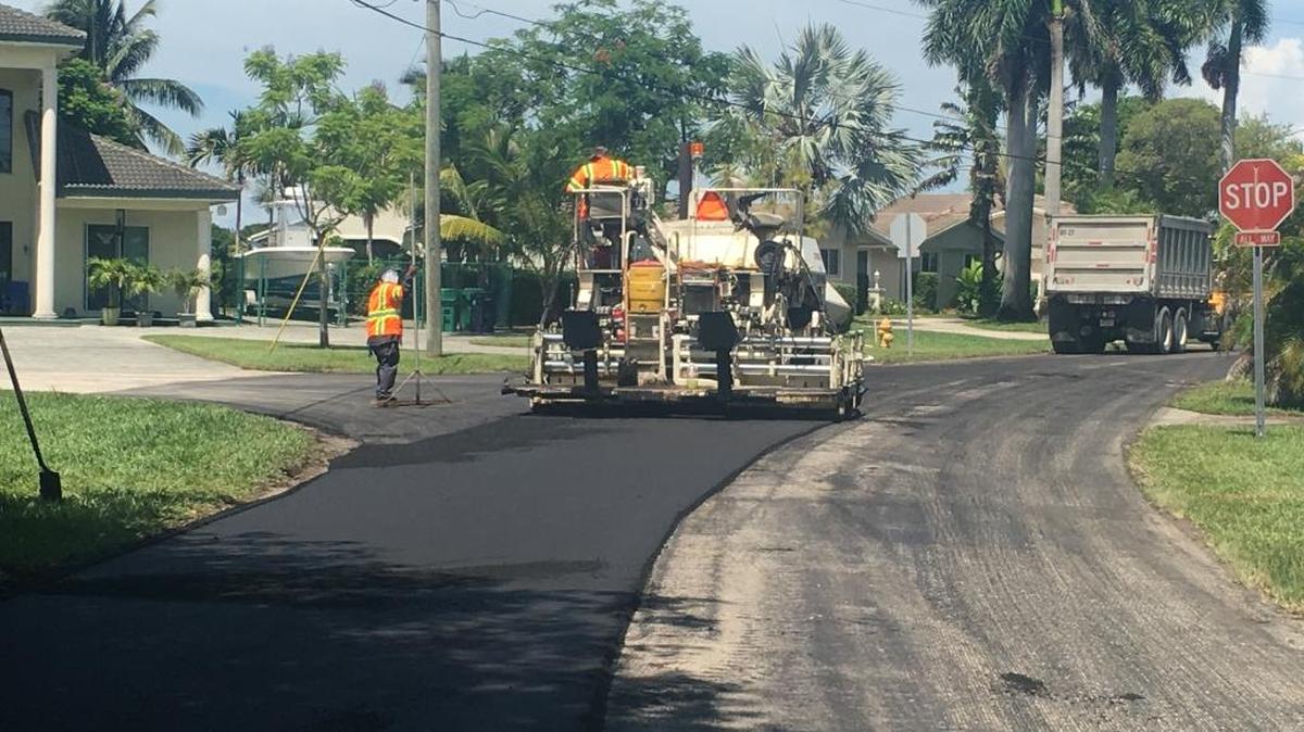 Workers repave a stretch of road in Cutler Bay. Miami-Dade has a plan to spend about $1.7 million on similar projects, using the county’s half-percent transportation tax. It’s a legal expense, but a transportation board tried to block the expenditure in favor of bike paths and greenways.