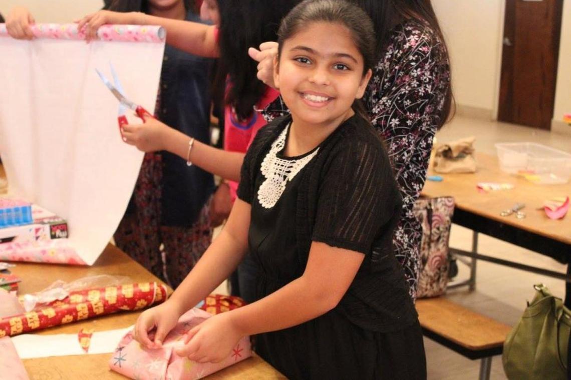 Amal Ramsan helps wrap toys during the Muslim Women’s Organization of South Florida’s toy drive during Ramadan in 2016. The organization will again be holding a toy drive during Ramadan, which begins Saturday.