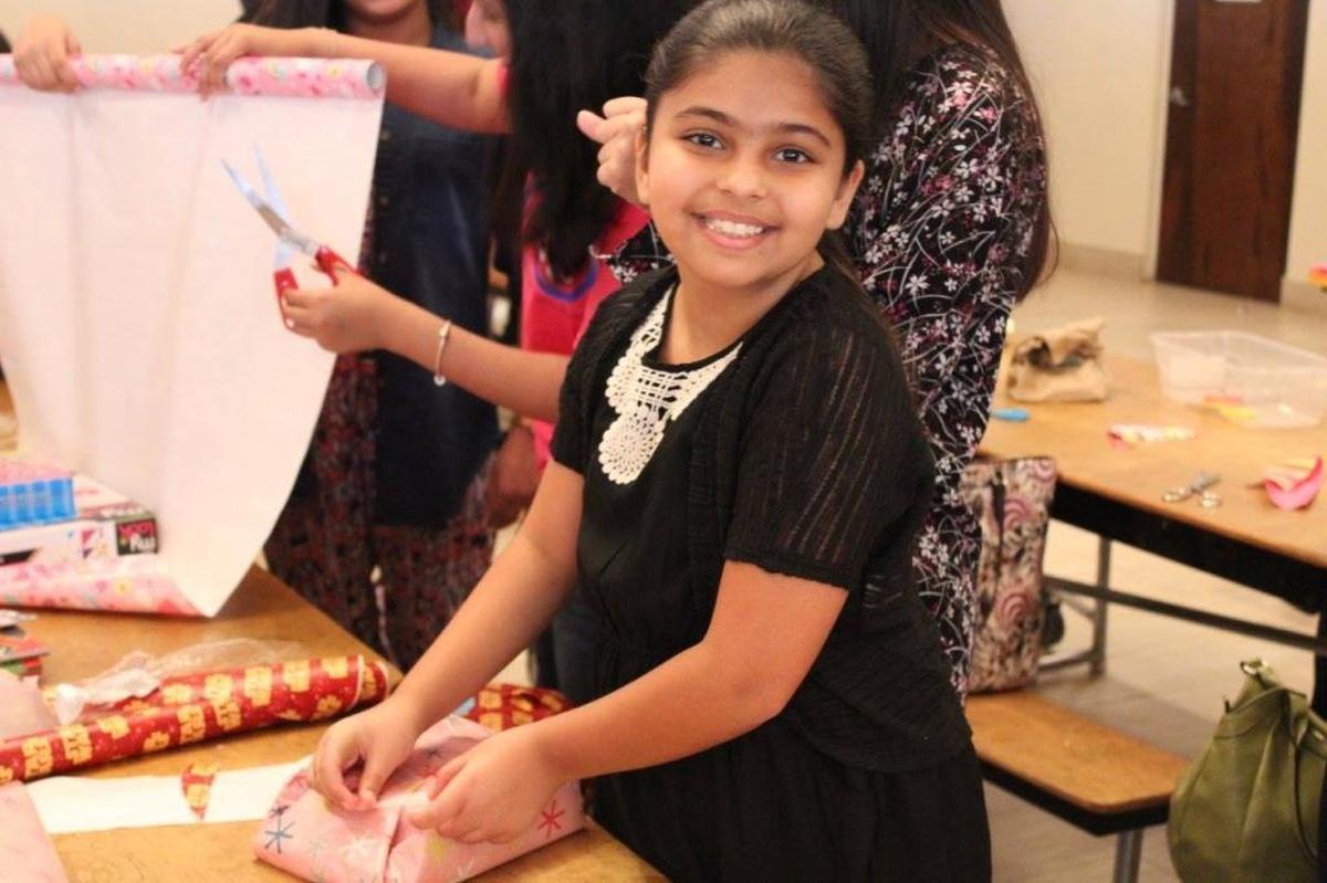 Amal Ramsan helps wrap toys during the Muslim Women’s Organization of South Florida’s toy drive during Ramadan in 2016. The organization will again be holding a toy drive during Ramadan, which begins Saturday.