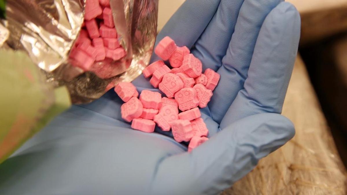 U.S. Customs and Border Protection officers show Molly pills that were logged into then released from evidence at their secret facility in Miami-Dade County Tuesday June 9, 2015. There is an imprint of Route 66 on them. The secret CBP bunker holds millions of dollars in seized drugs, guns and other contraband that are used for federal investigations and then burned.
