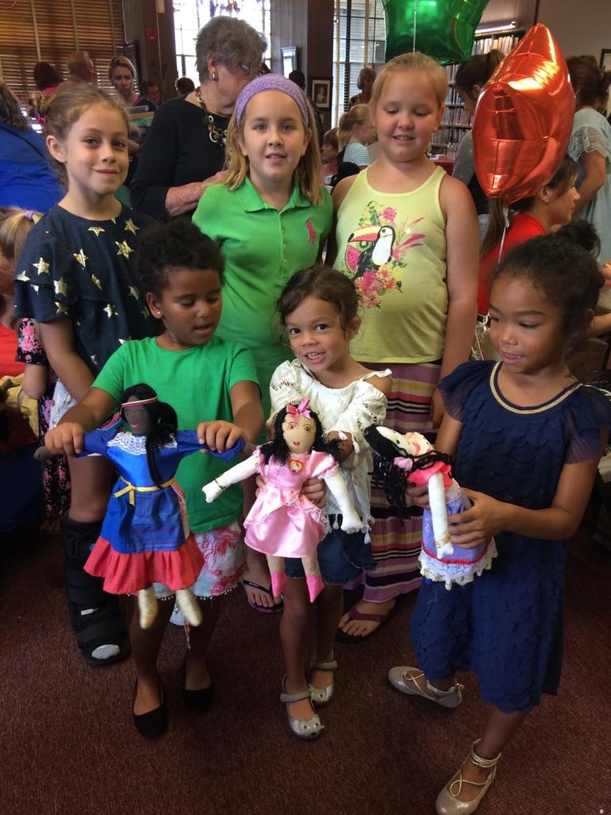 Girls play with handmade dolls at the Dolls By Carmen booth at the second annual Brockway Artisan Fair in Miami Shores. Back row, from left: Lily Calli, Mikaela Debach and Daniela Debach. Front row, from left: Adair Stamey, Ella Calli and Hadley Hale.