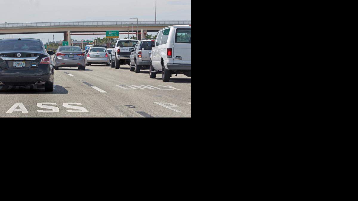 
Commuters scramble to exit on Northwest 107th Avenue off SR-836 on the first weekday of the new traffic shift on the expressway Monday, March 23, 2015.
