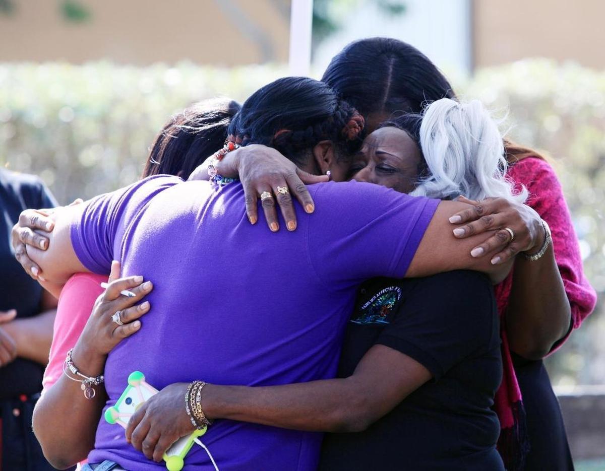 Community residents console each other during at a gathering at Goulds Park on Saturday, Dec. 16, 2017, one day after 2-year-old Carnelle Williams-Thomas was shot and killed.