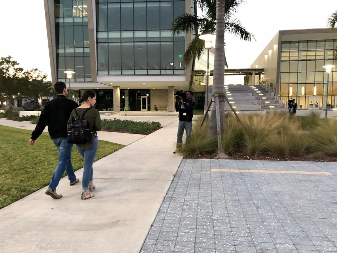 FIU students Lynnet Gomez and Manny Perez walking to the family reunification center at FIU seeking information about a friend whose car was trapped when the bridge collapsed.