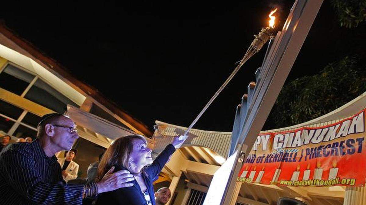 
Arthur and Shirley Sotloff, the parents of Steve Sotloff, a journalist beheaded by ISIS in September, remember their son by lighting the first Hanukkah candle at a community Hanukkah celebration in Southwest Miami-Dade on Tuesday, Dec. 16, 2014. The event, was organized by the Chabad Center.
