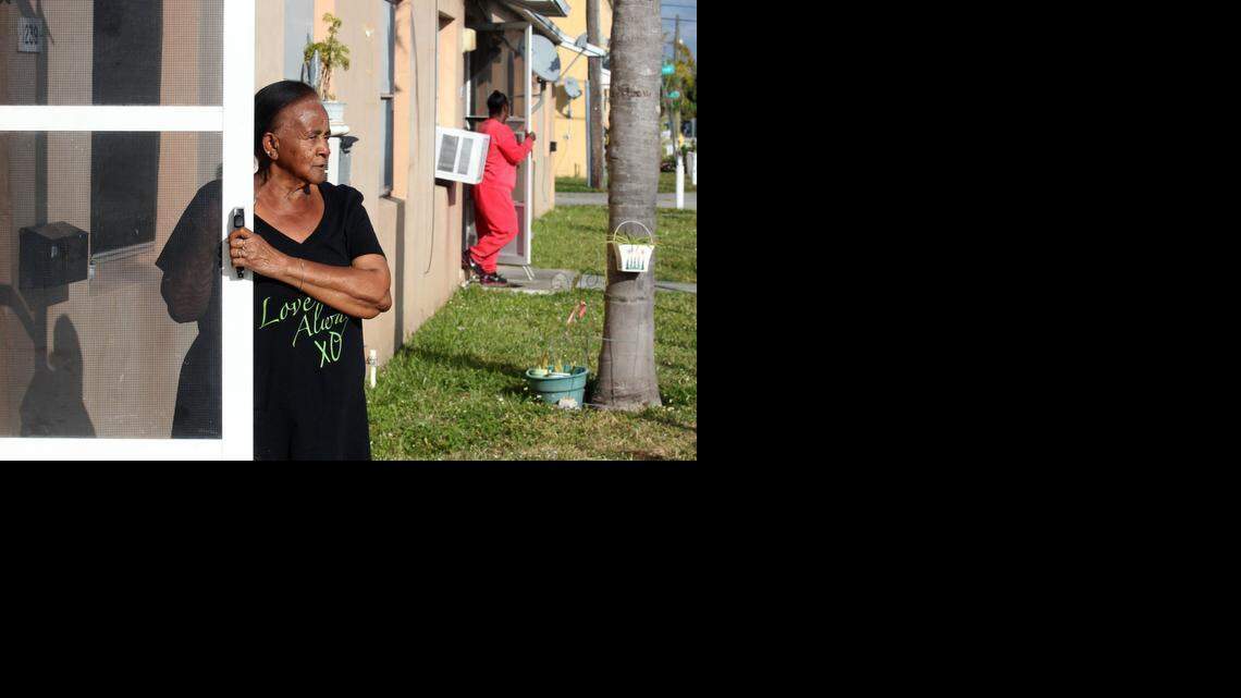 
Waltermae Martin looks out her front door in Liberty Square on Northwest 63 Street. Martin has lived in the project since 1973. Miami-Dade County has a $74 million dollar plan to move tenants of Liberty Square out of Miami's most notorious public-housing project, and into new digs in order to bulldoze and redevelop the complex.
