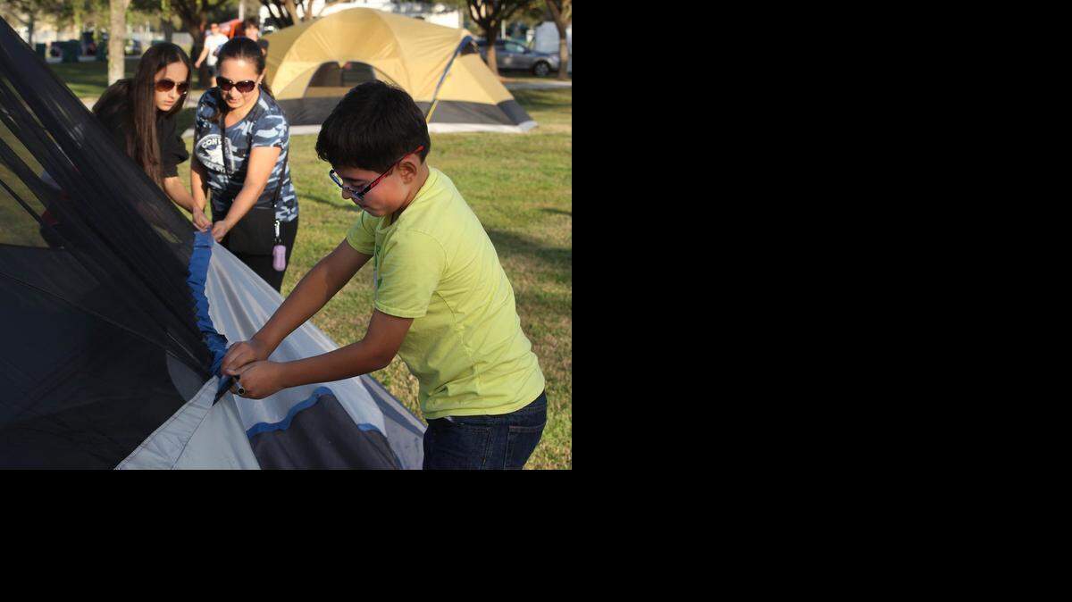 
David Franco and his sister Sarah Franco, left and mom Francy Franco put up their tent Friday at J.C. Bermudez Park in Doral. Families from all over Miami-Dade County flocked to the park to join in for the city’s ‘Camping Under the Stars’ event, which was held in partnership with the local Boy Scouts.

