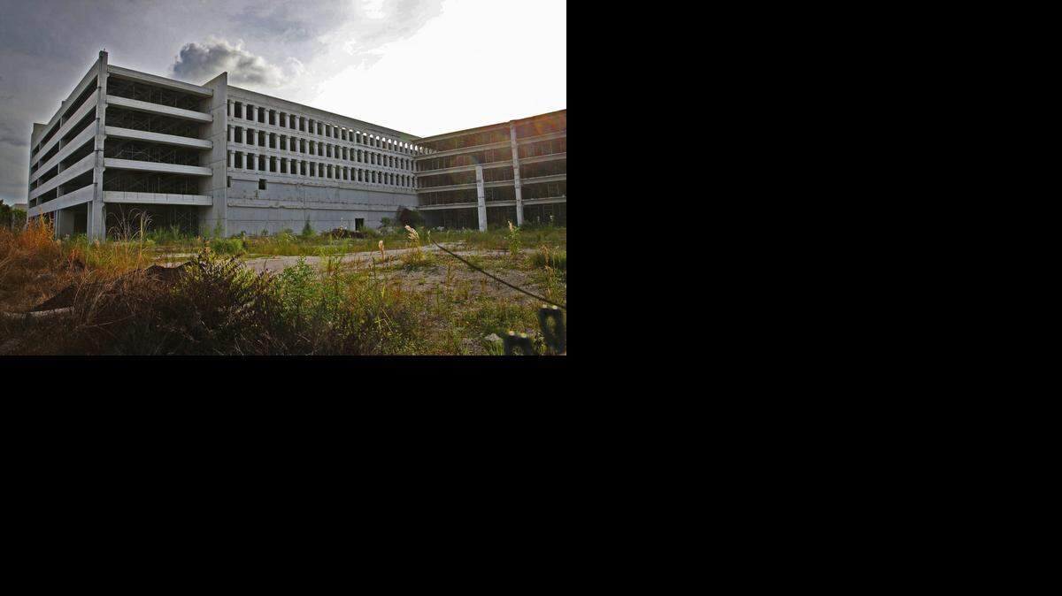 
Two years after a garage collapsed at Miami Dade College’s west campus in Doral, there is still no relief for the more than 6,000 students who attend the college there. The college has said its hands are tied due to litigation. Students either have to park at Miami International Mall and take a shuttle or find a spot along 117th Avenue, a public right-of-way, and walk. This is the vacant garage on Wednesday, October 8, 2014.
