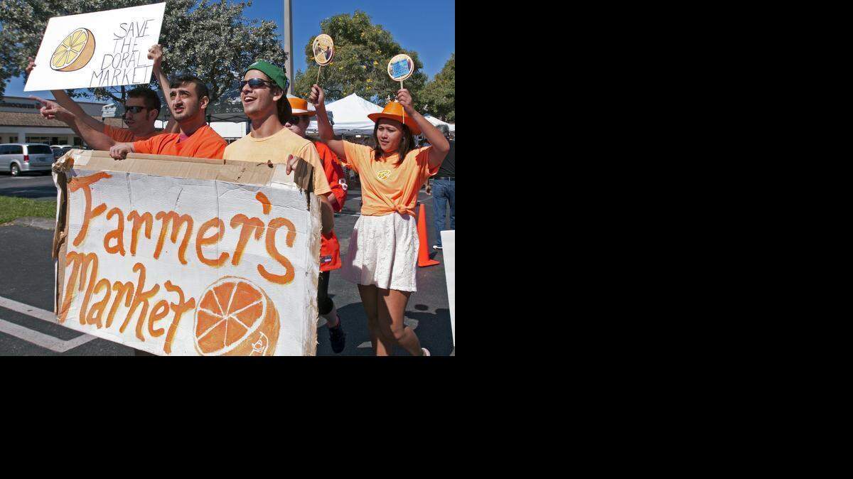 
Supporters of the Doral Farmers Market protest on Sunday about possibly relocating the market from its current location at Northwest 97th Avenue and 41st Street in the Doral Centre plaza’s parking lots. The city is voting Wednesday on a proposed ordinance that calls for farmers markets to set up 500 feet from 41st Street/Doral Boulevard.


