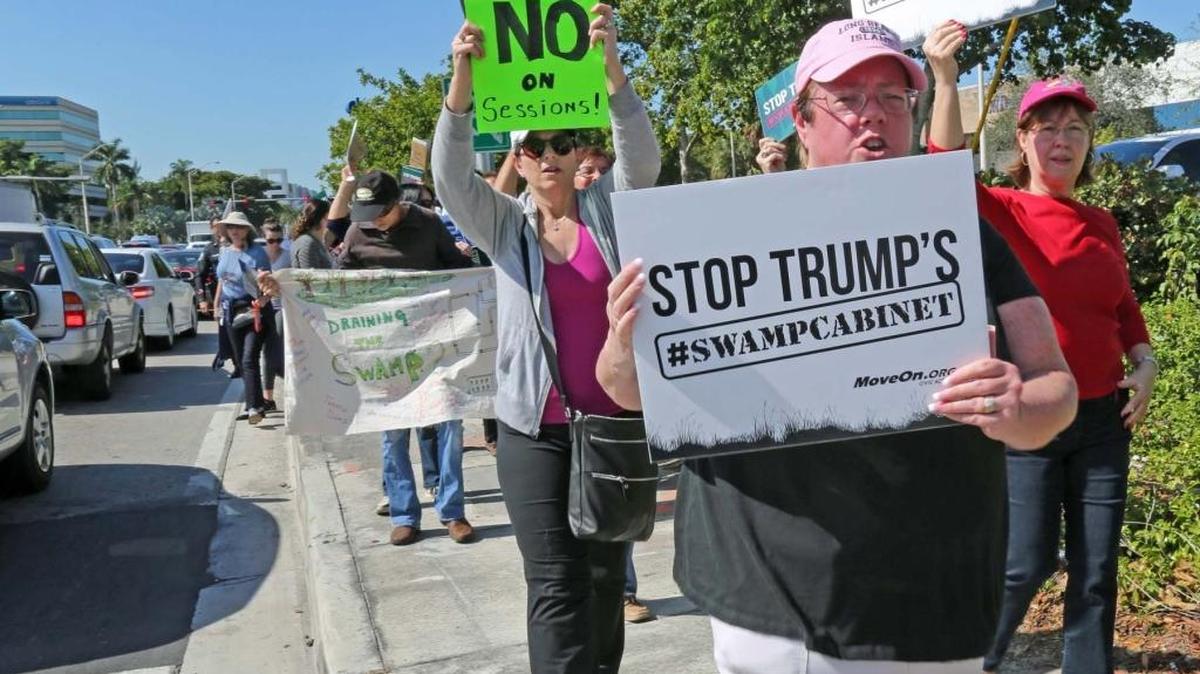 Protesters belonging to 'RISE UP AMERICA' and 'MOVEON.ORG' demonstrate in front of Sen. Marco Rubio's Doral office on Tuesday, Jan. 31, 2017. They want Rubio to stand up to Trump on his cabinet picks and Trump’s recent order denying entry into the United States from people coming from seven Muslim counties.