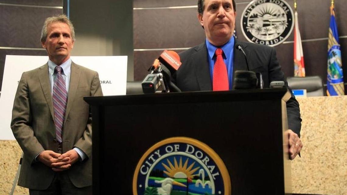 Former Doral City Manager, Joe Carollo (right), speaks at a press conference in 2013 as Mayor Luigi Boria stands beside him.