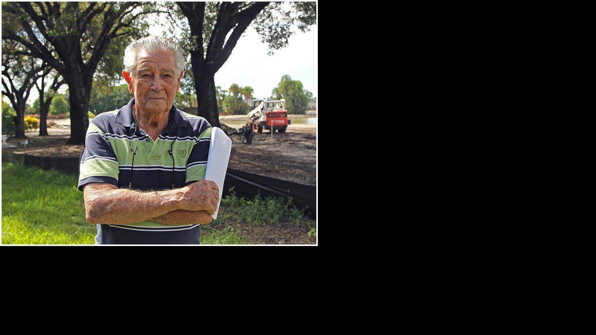 
Retiree Morgan Levy is fighting against the planting of palms near his property line that will obscure his view of the golf course. Areca palms were planted Monday on the several courses at the Trump National Doral Miami. 
